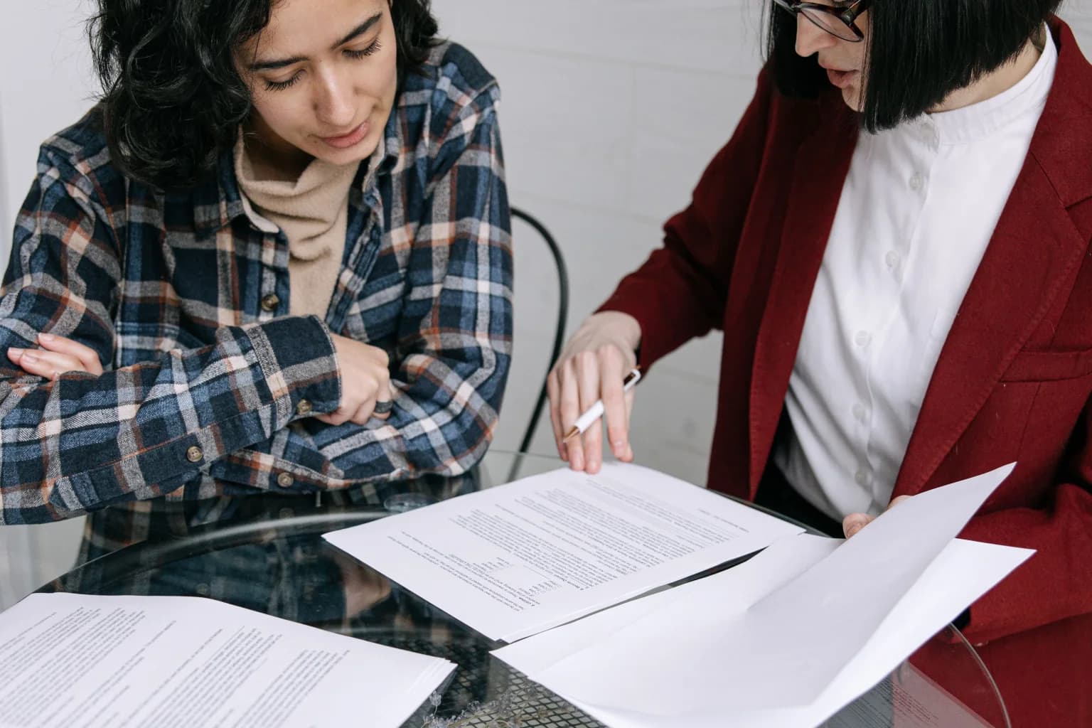Two staff members reviewing printed operating documents together.